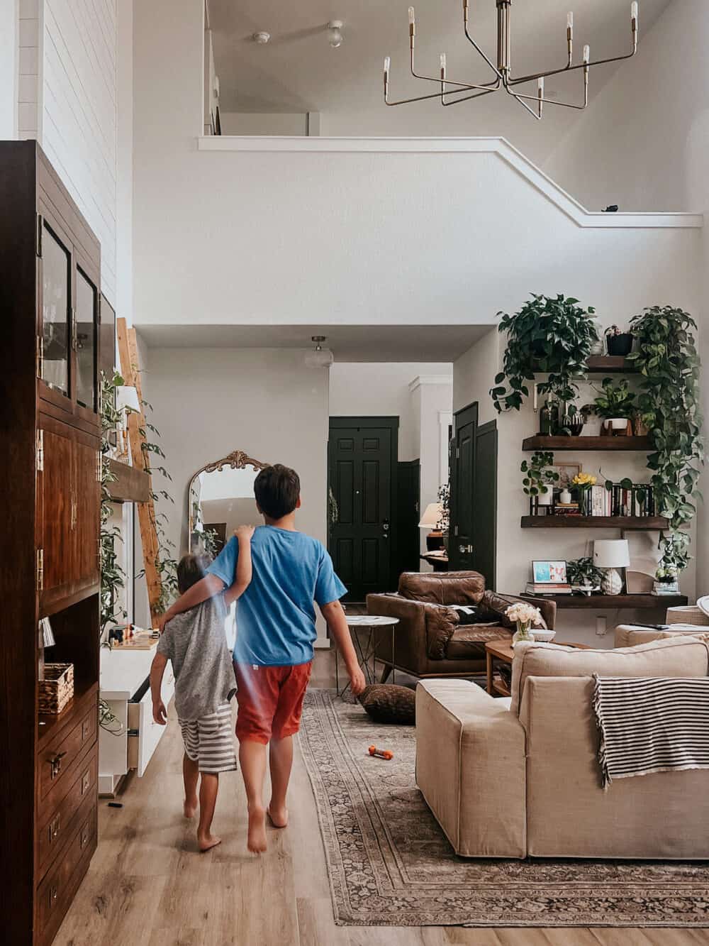 two boys walking through a house arm in arm