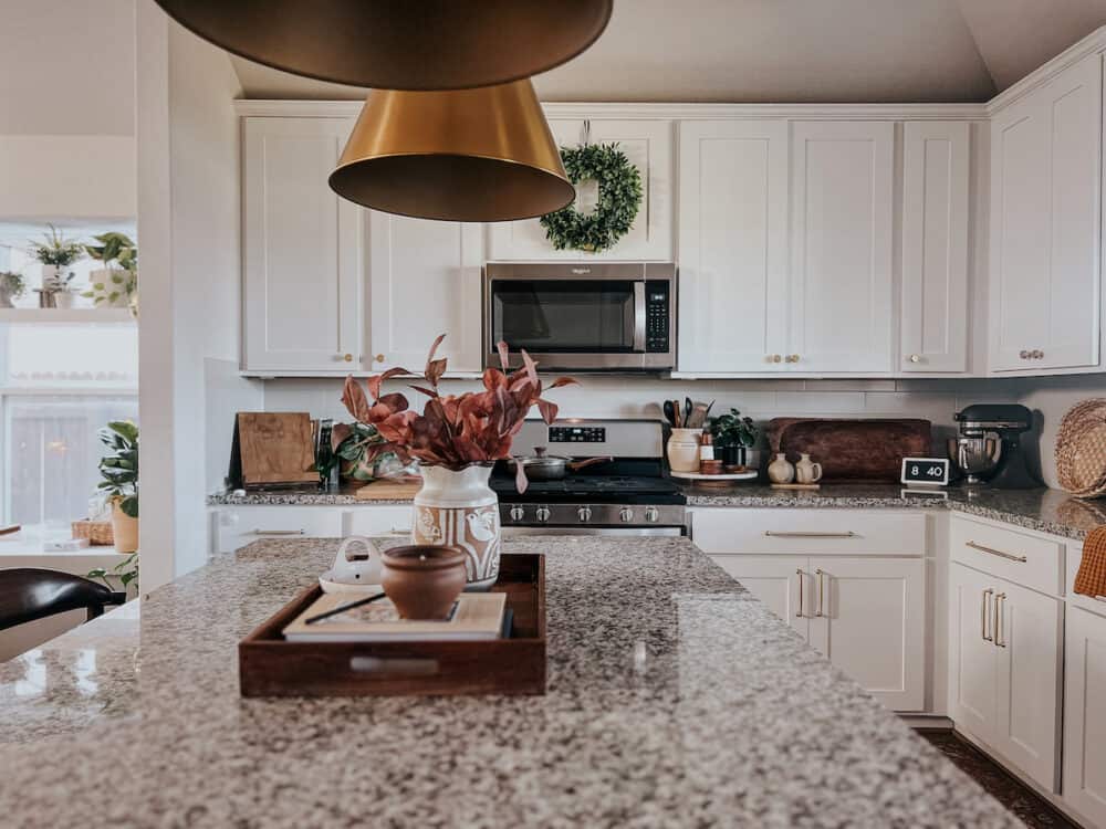 Kitchen decorated for fall with fall stems and a fall scented candle