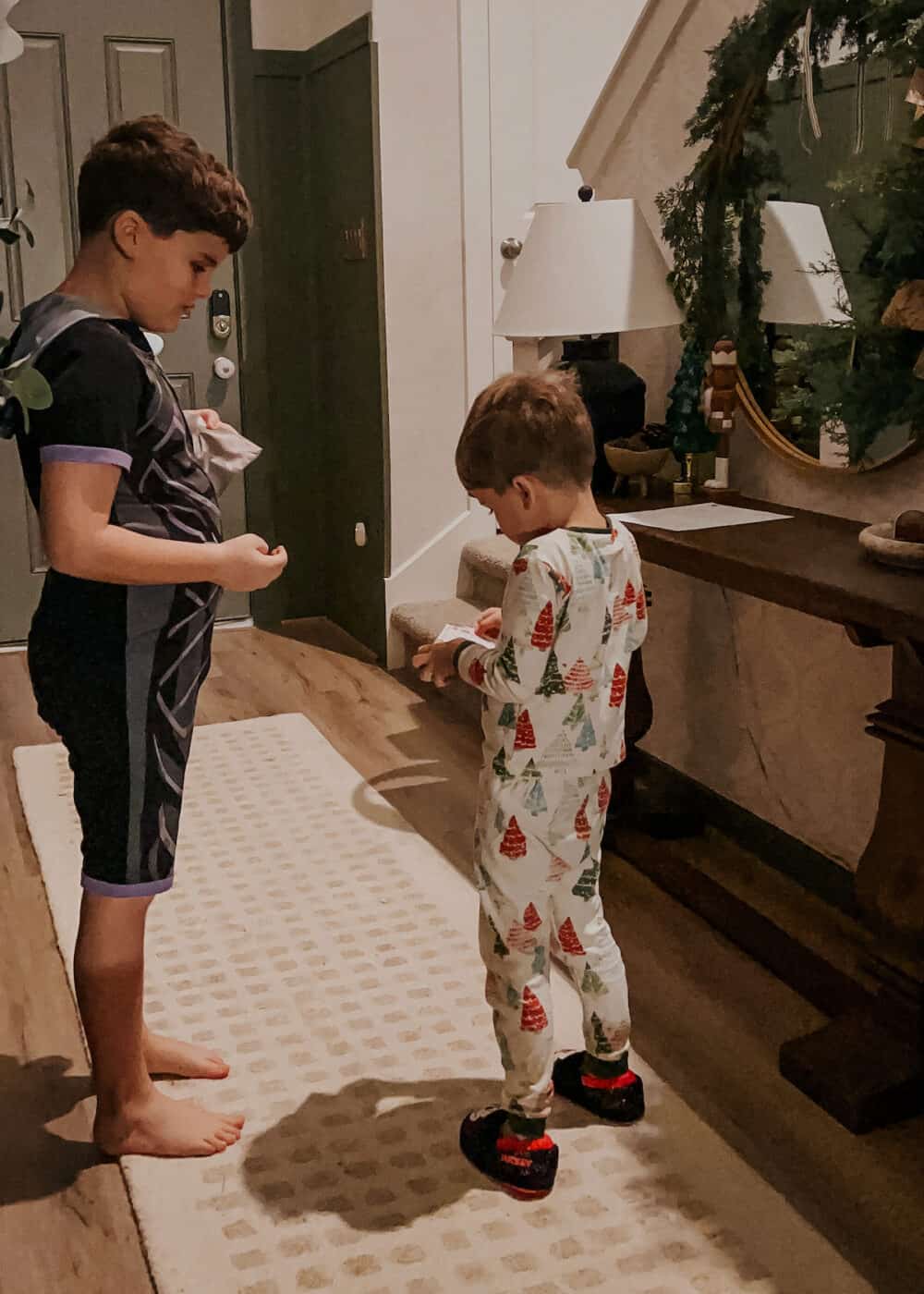 two boys opening clues for a Christmas scavenger hunt