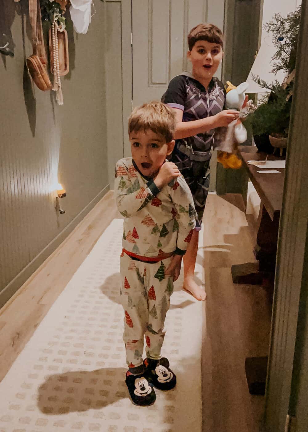 two boys playing a Christmas scavenger hunt 