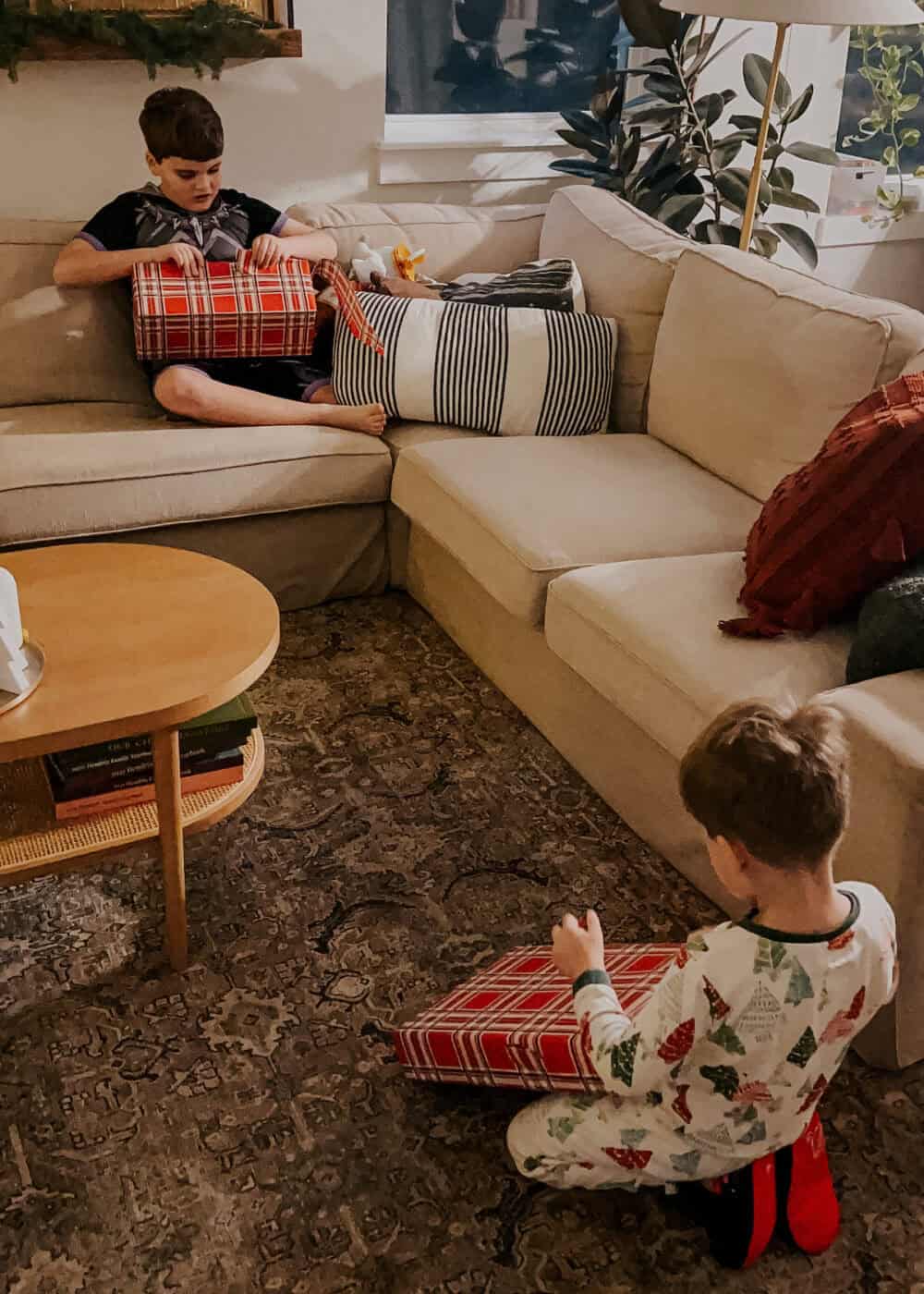 two young boys opening a Christmas gift