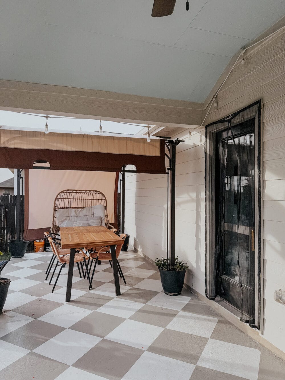 a patio with a painted concrete floor and a dining table and chairs