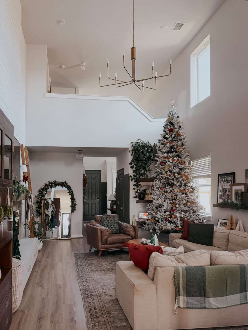 living room with tall ceilings decorated for Christmas