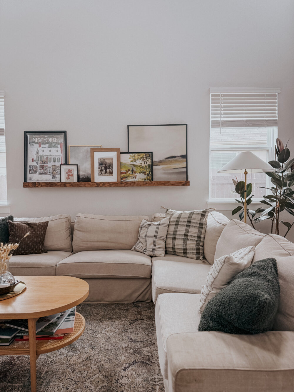 living room with a cozy sectional and an art ledge above the sofa