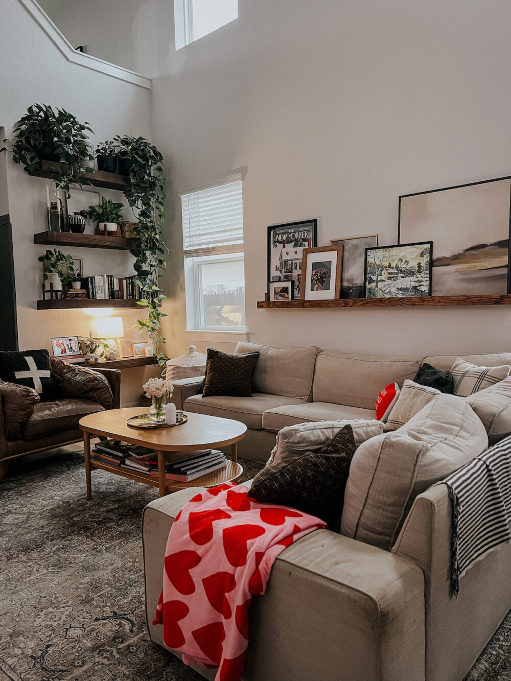 living room decorated for Valentine's Day with a red and pink throw blanket on the sofa