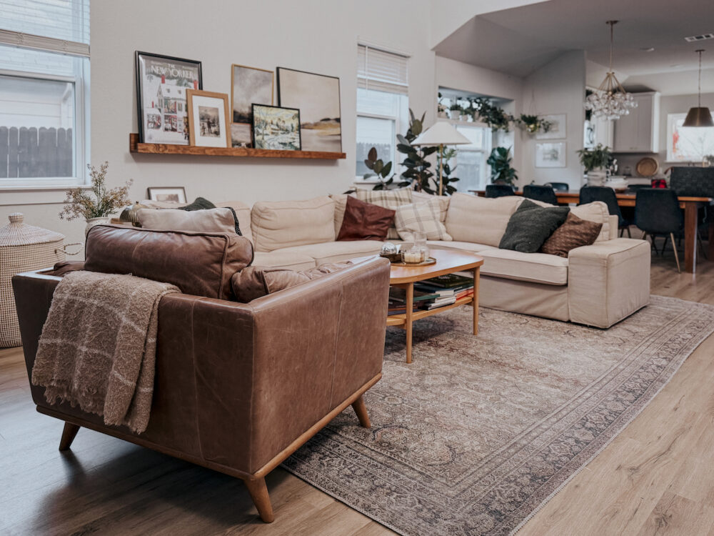a neutral living room with a leather chair and a white sofa