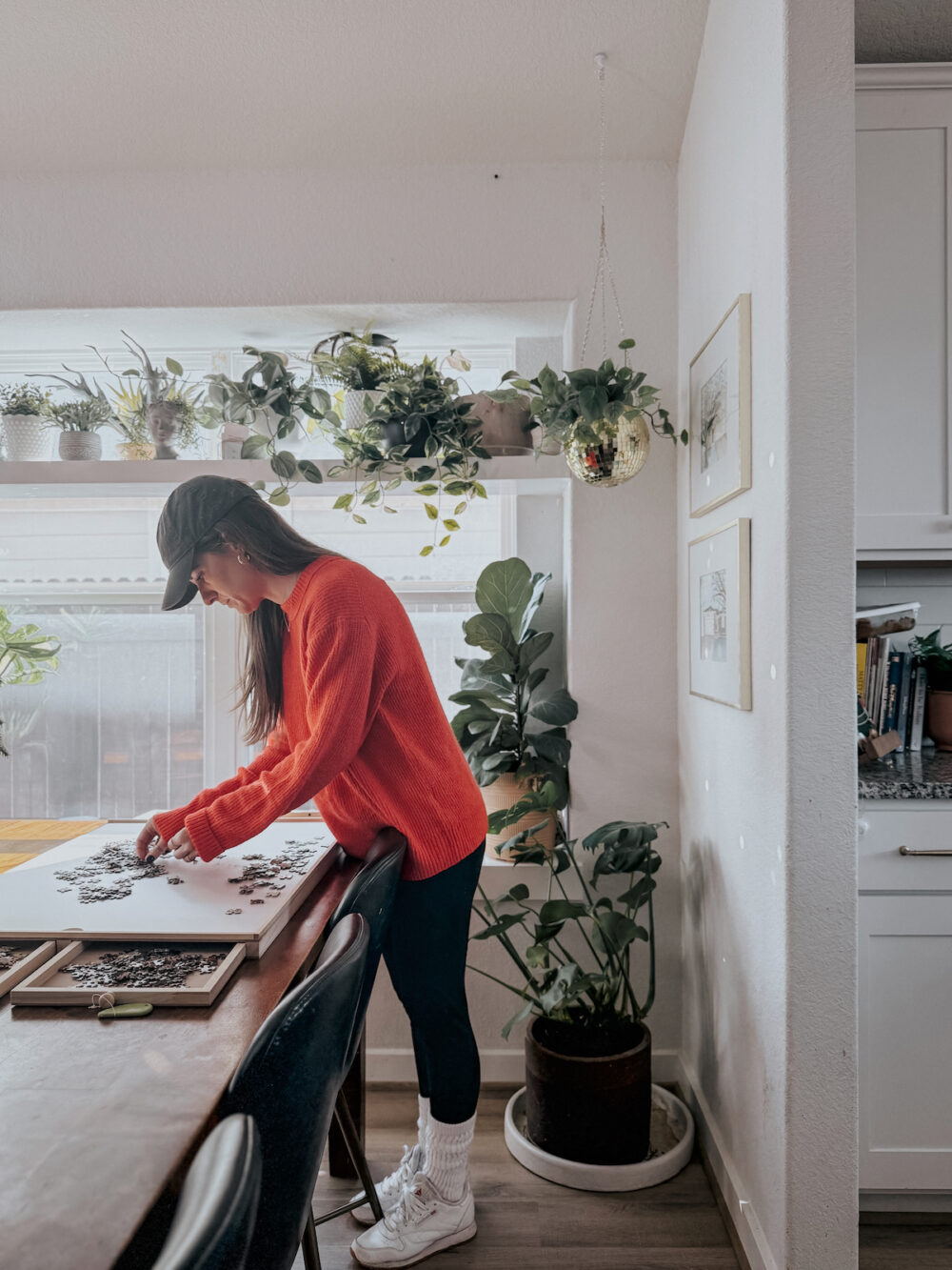Woman working on a puzzle on a puzzle board