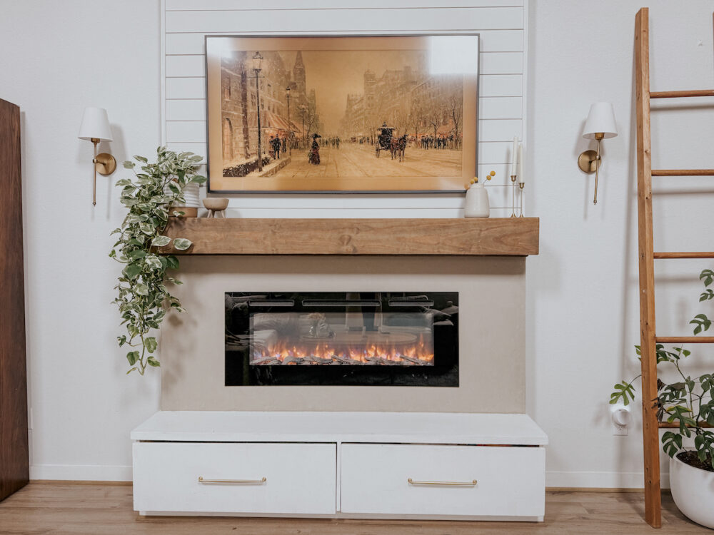 Living room fireplace with a frame TV hanging above it 