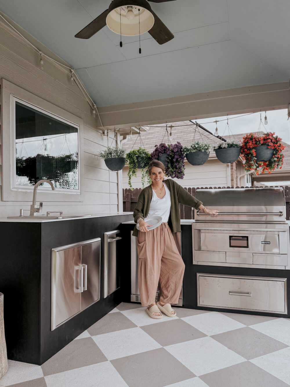 Woman posing in an outdoor kitchen from RTA Outdoor Living
