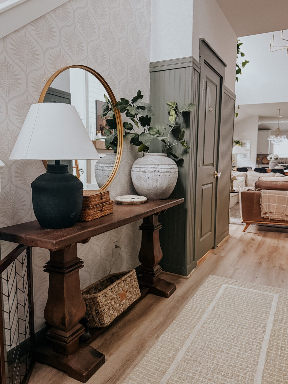 A home entry with wallpaper and a wooden entry table 