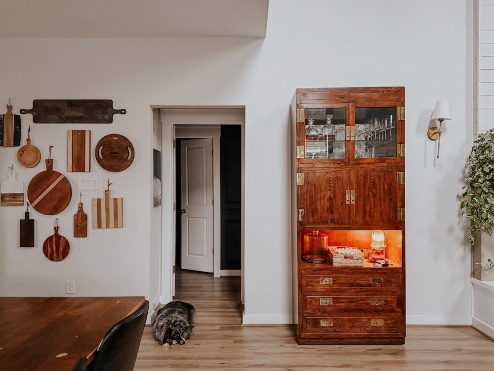 a clean home dining room with a large china cabinet 