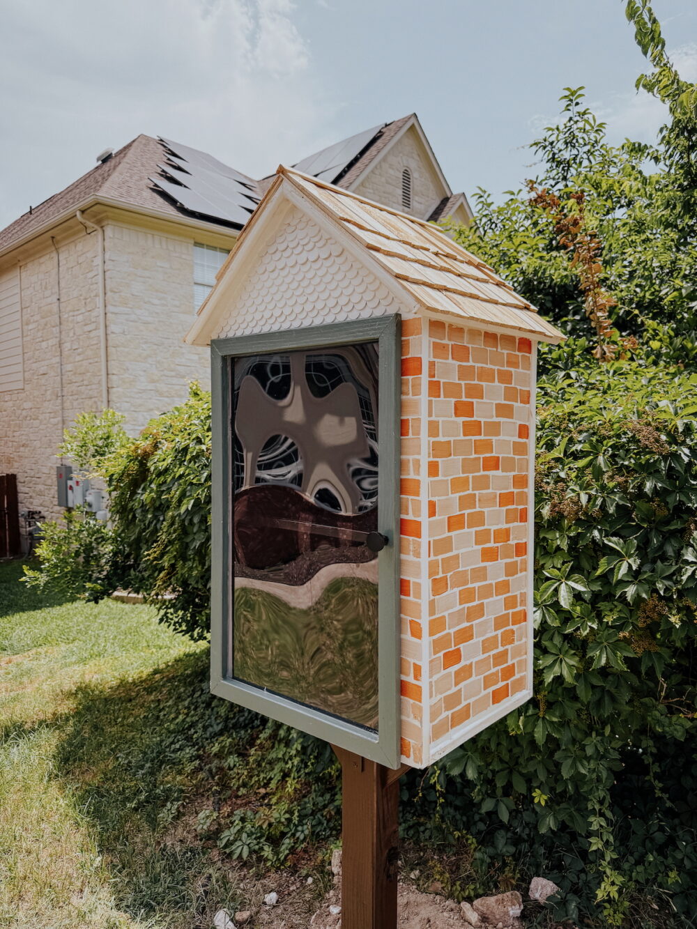 Little Free Library installed in a front yard