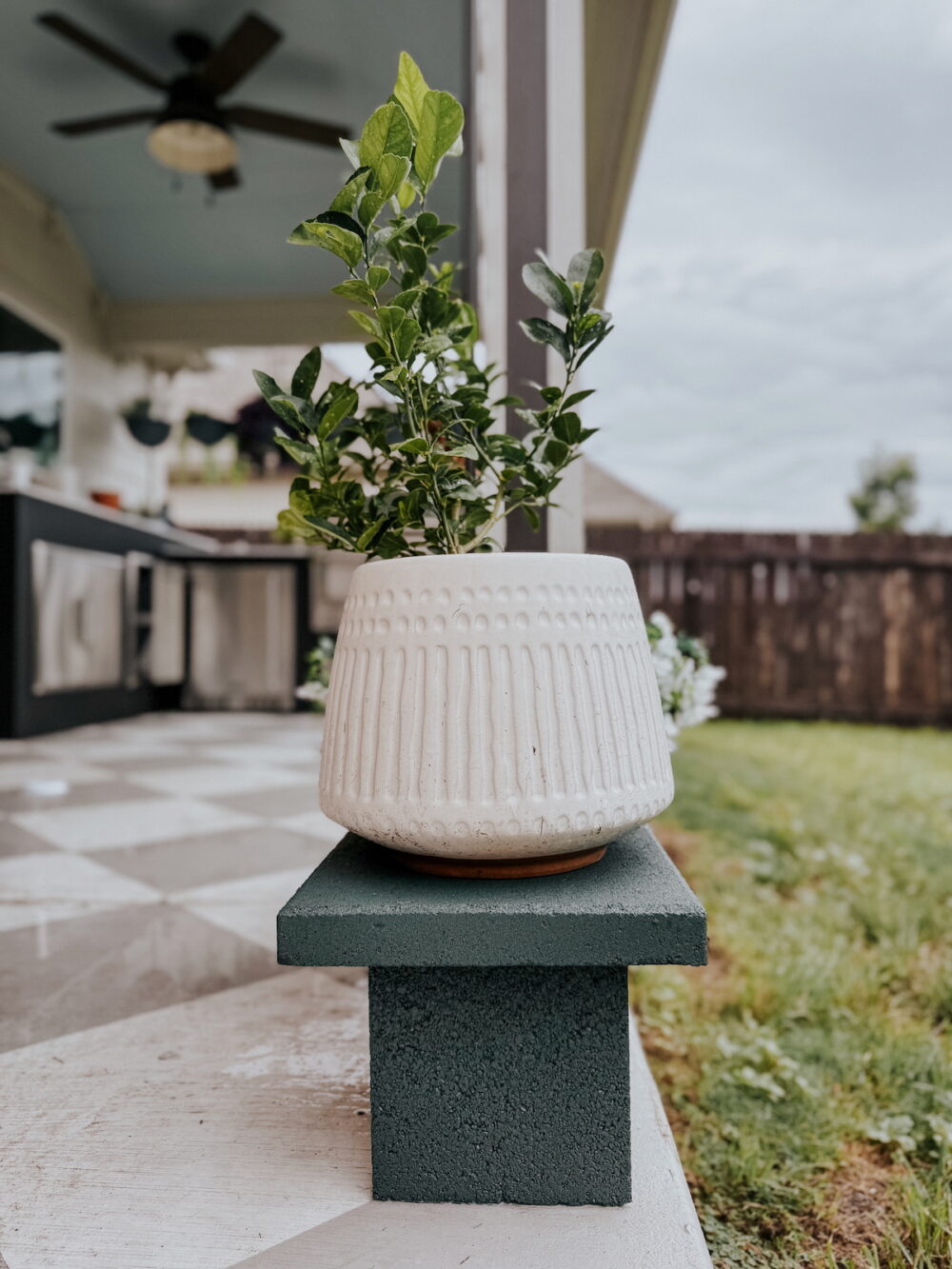simple outdoor plant stand made from concrete blocks