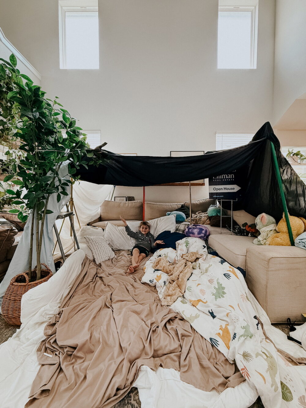 large living room fort with a young boy in it