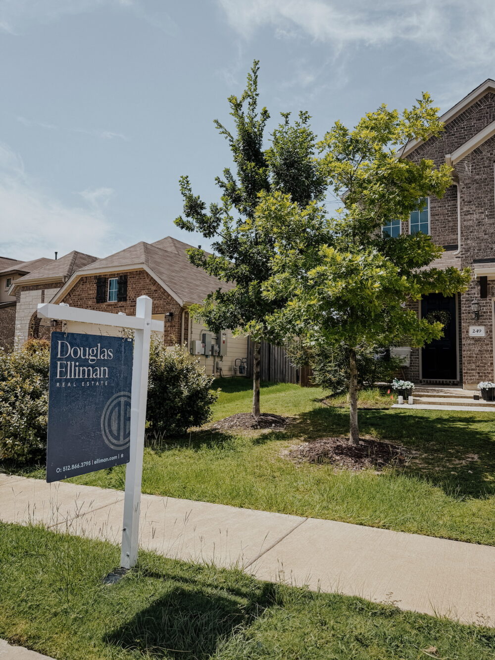 front yard with a for sale sign in front