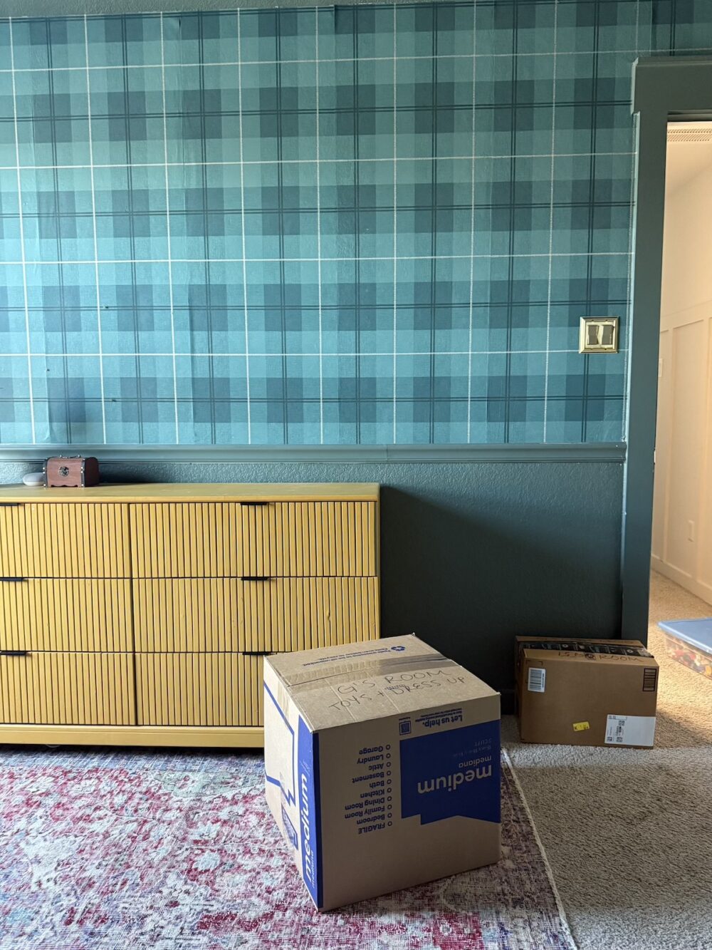 child's bedroom with boxes being packed for a move
