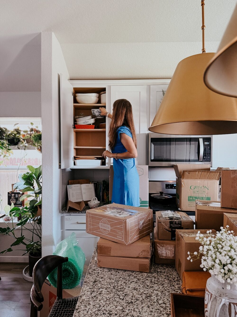 woman packing a kitchen for a move