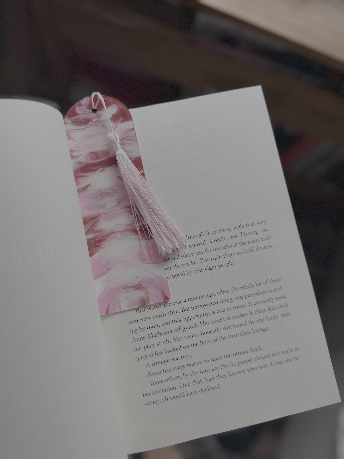 open book with a pink swirl painted bookmark 