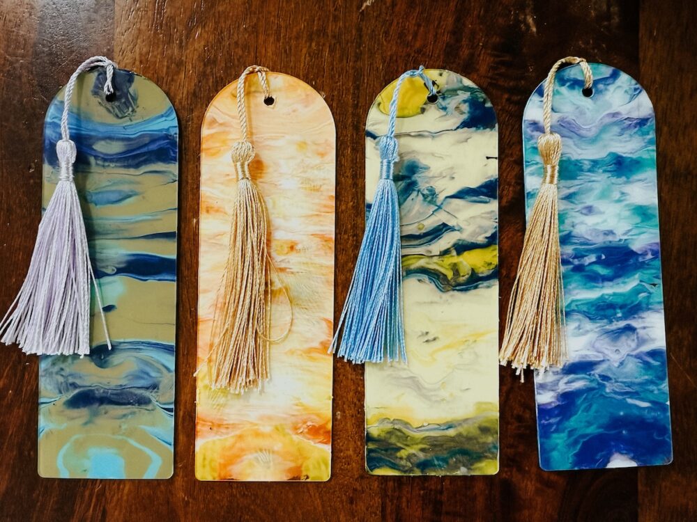 four painted DIY bookmarks sitting on a table
