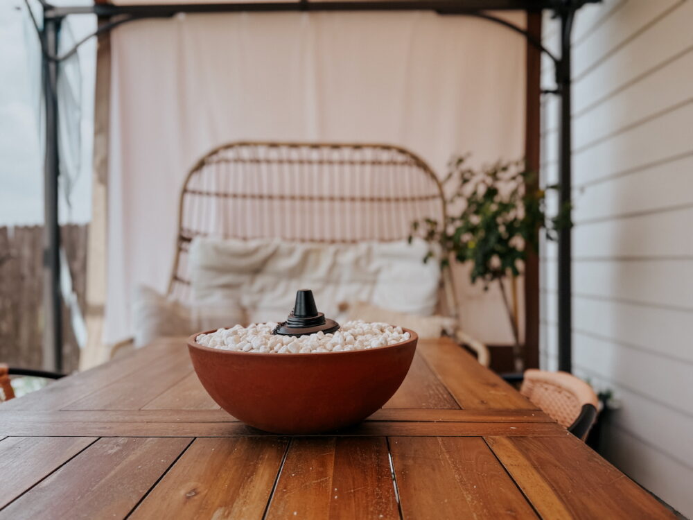 outdoor table with a terra cotta colored tabletop fire bowl 
