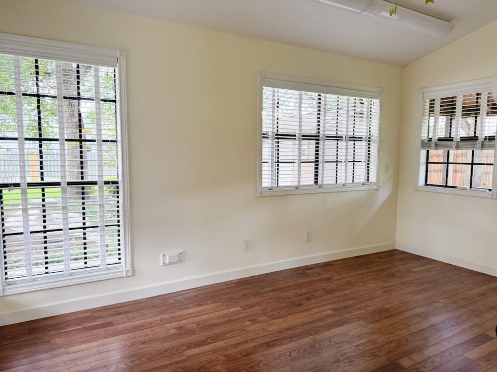empty sunroom with large windows and yellow walls 