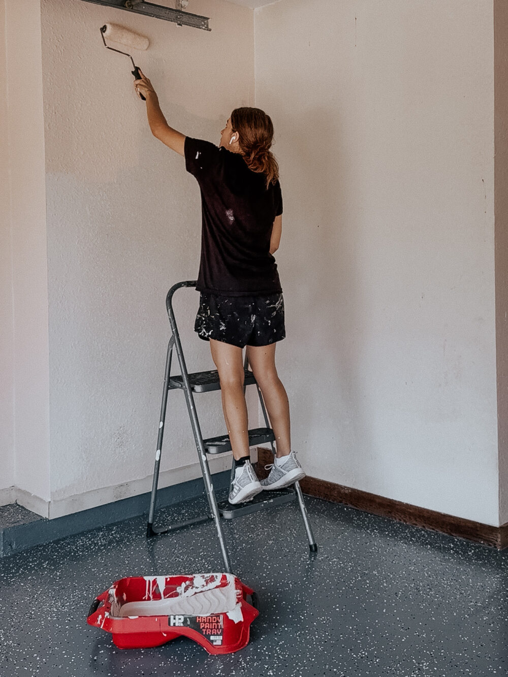 woman painting walls with Clare Wing It Paint 