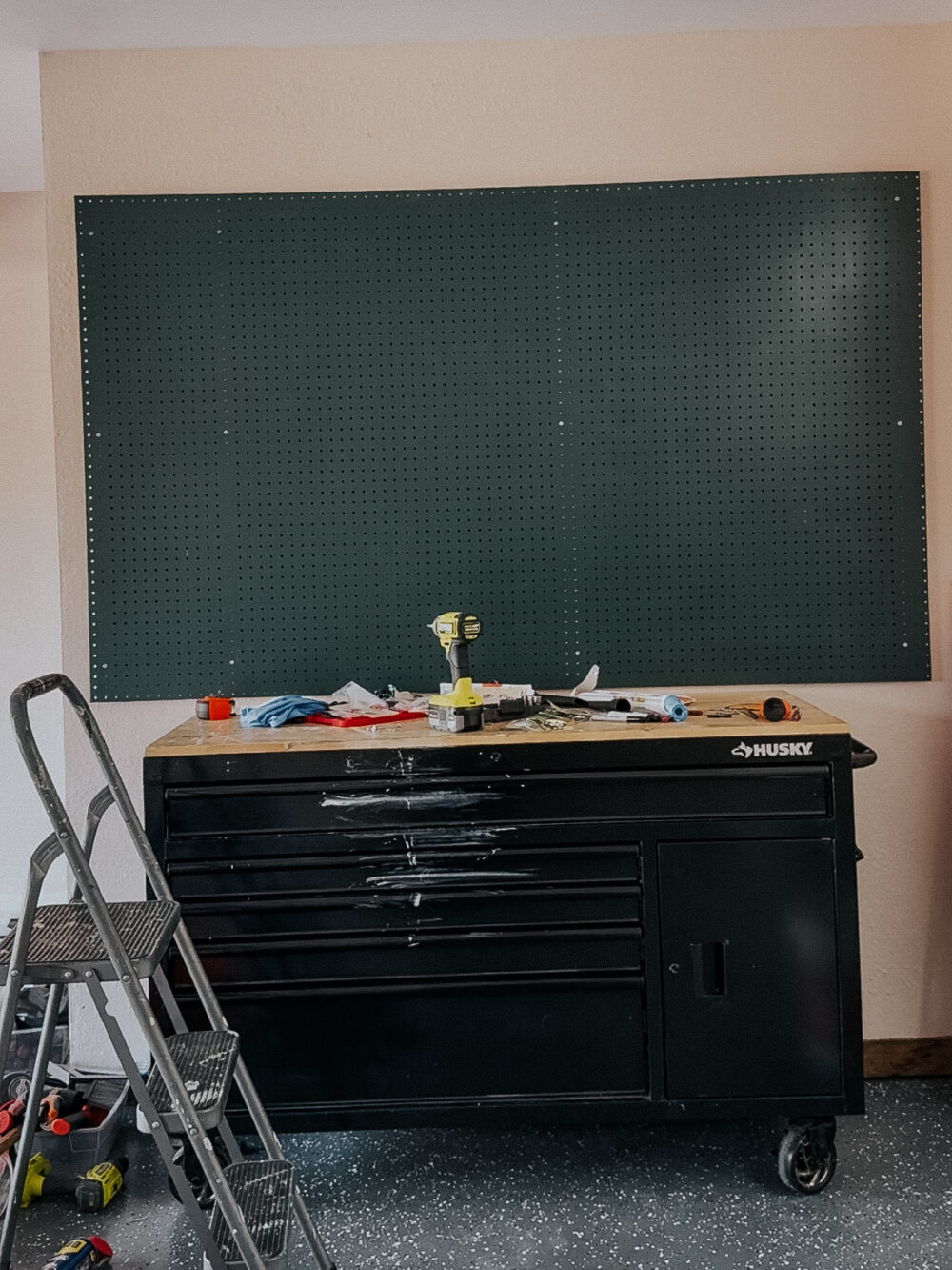 large garage pegboard hanging above a workbench