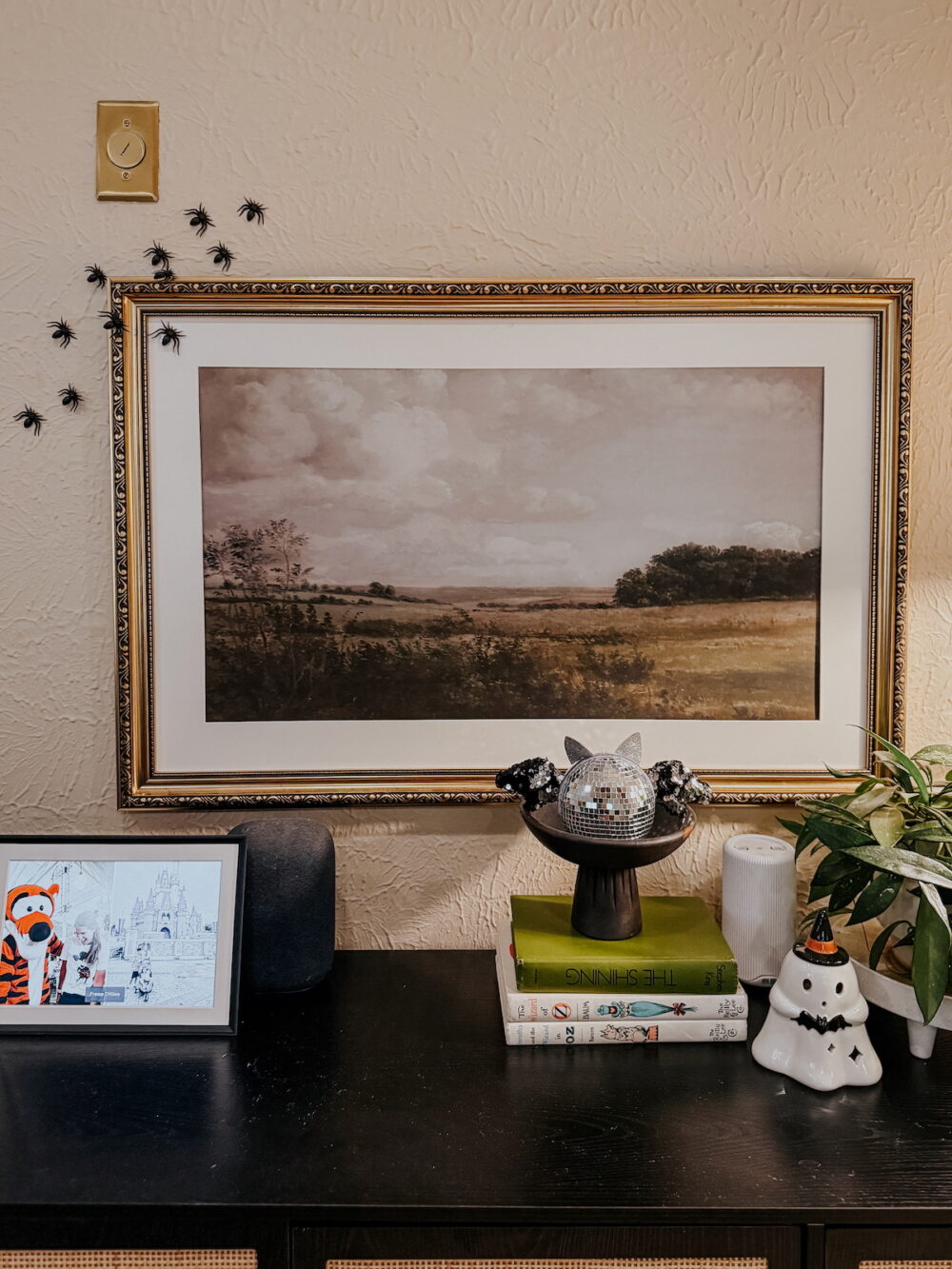 vignette decorated for Halloween with spiders crawling along the wall