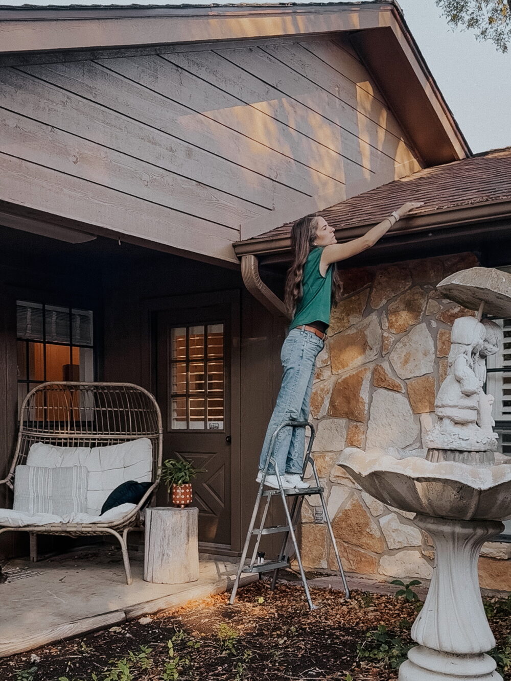 Woman cleaning gutters in a home 