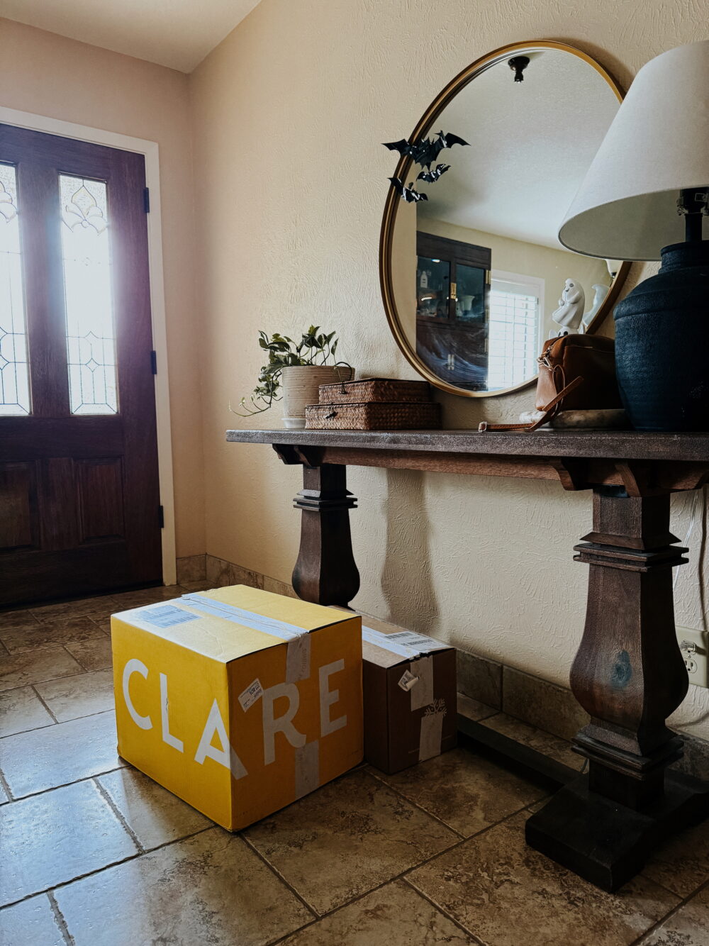 box of Clare paint sitting in an entryway