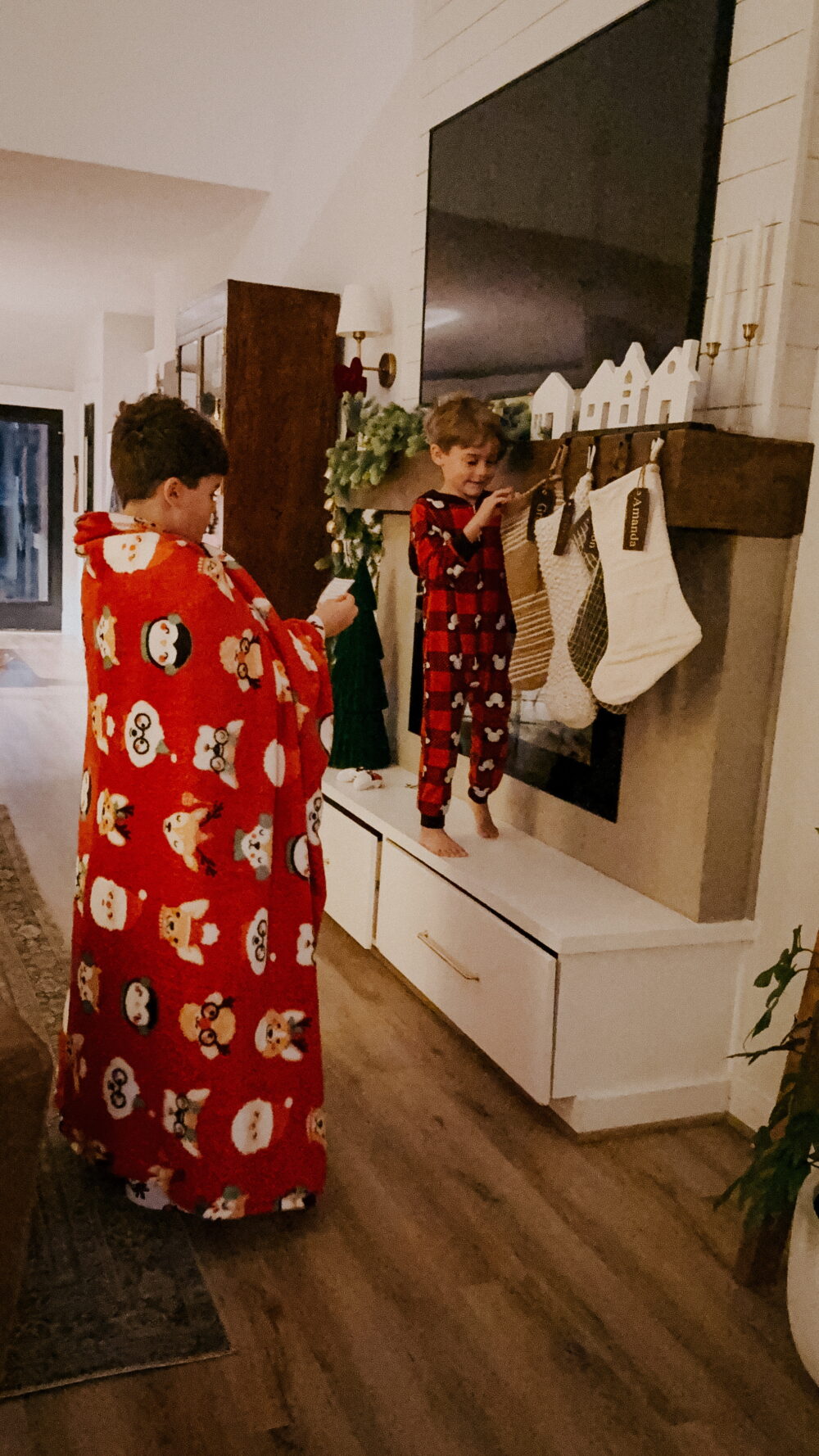 two young children looking for clues for a christmas scavenger hunt 