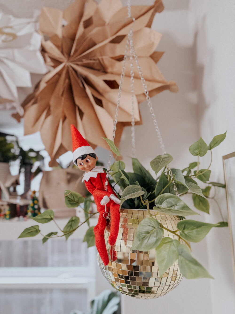 elf on a shelf hanging from a ceiling
