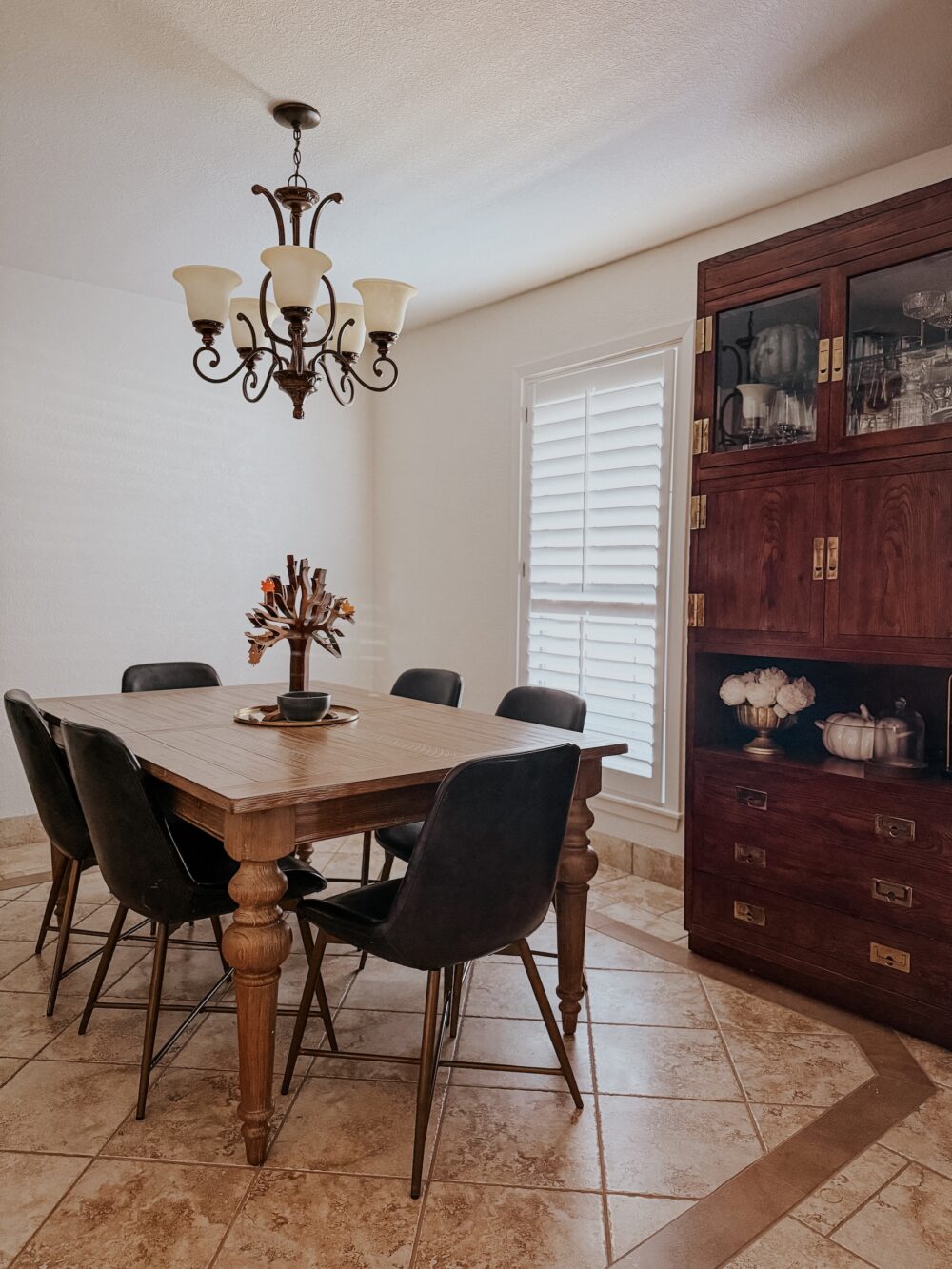 Small dining room with a large china cabinet and a dining room table 