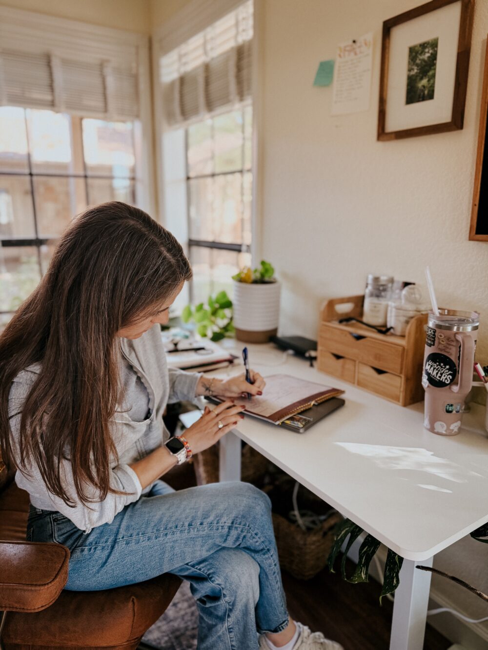 woman sitting at a desk organizing a calendar 
