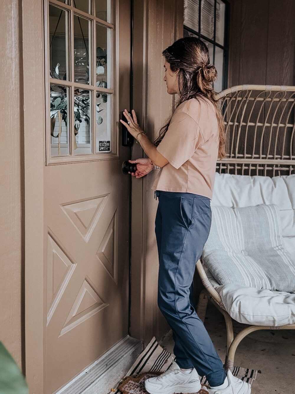 woman opening a door using a fingerprint keypad