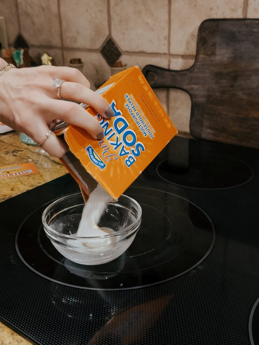 woman making a paste of baking soda and vinegar