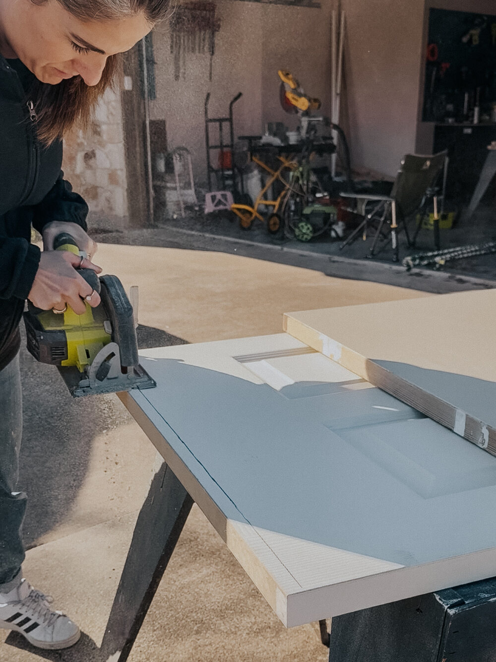 woman cutting down an interior door