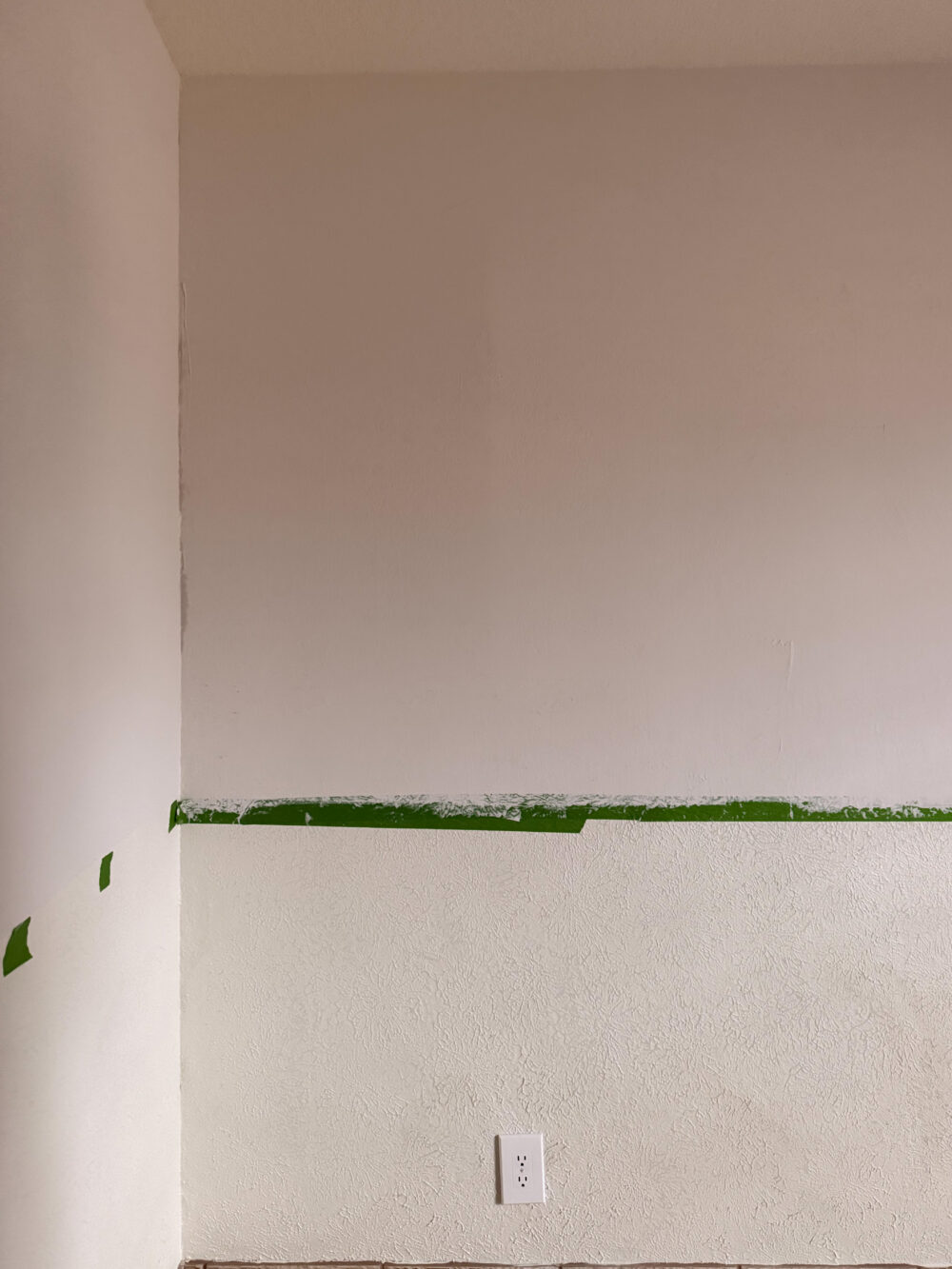 room with skim coating on the top half of the walls