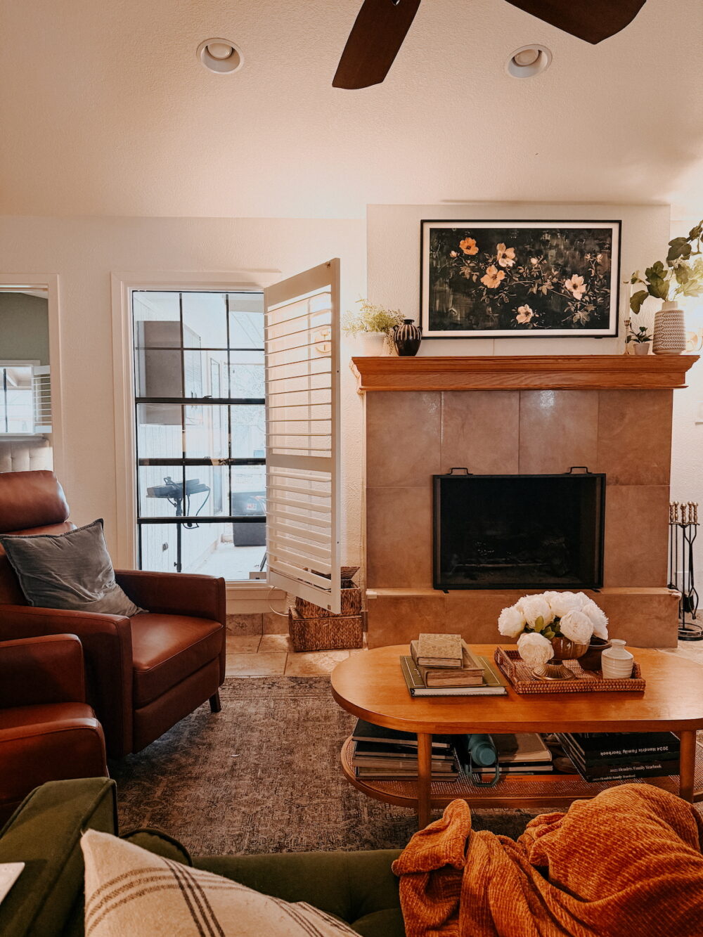 living room with a fireplace and an open window