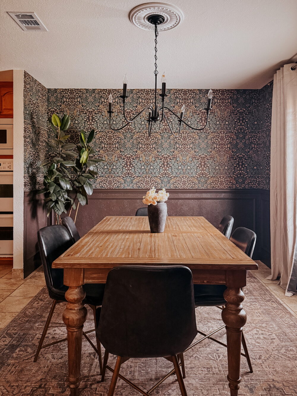 moody, traditional dining room with a ceiling medallion above the chandelier