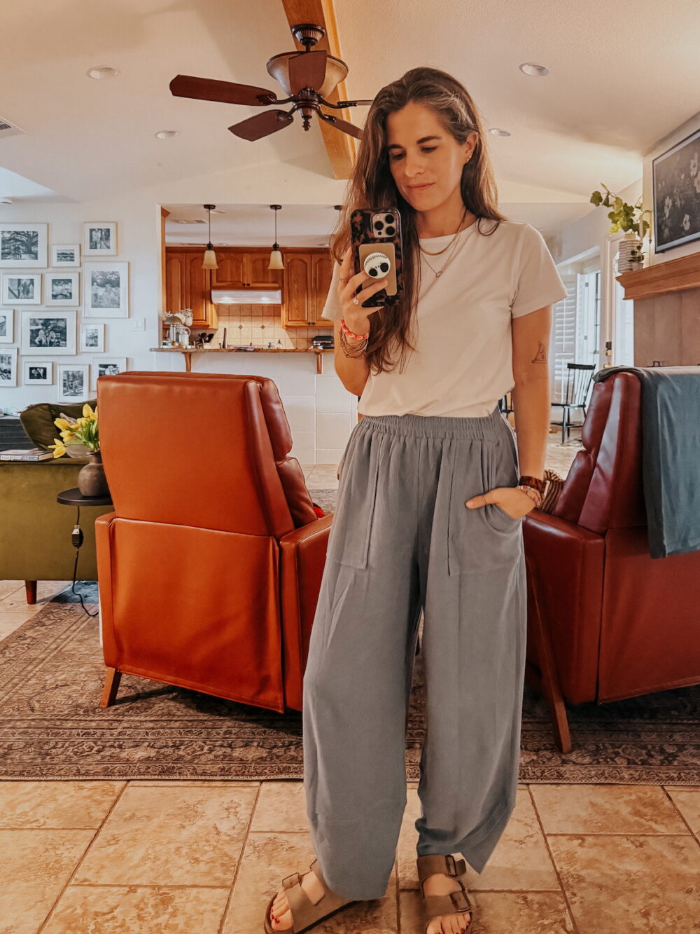 woman wearing blue palazzo pants and a white tee