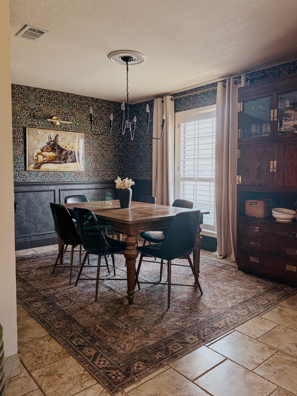 moody traditional dining room with floral wallpaper and brown walls