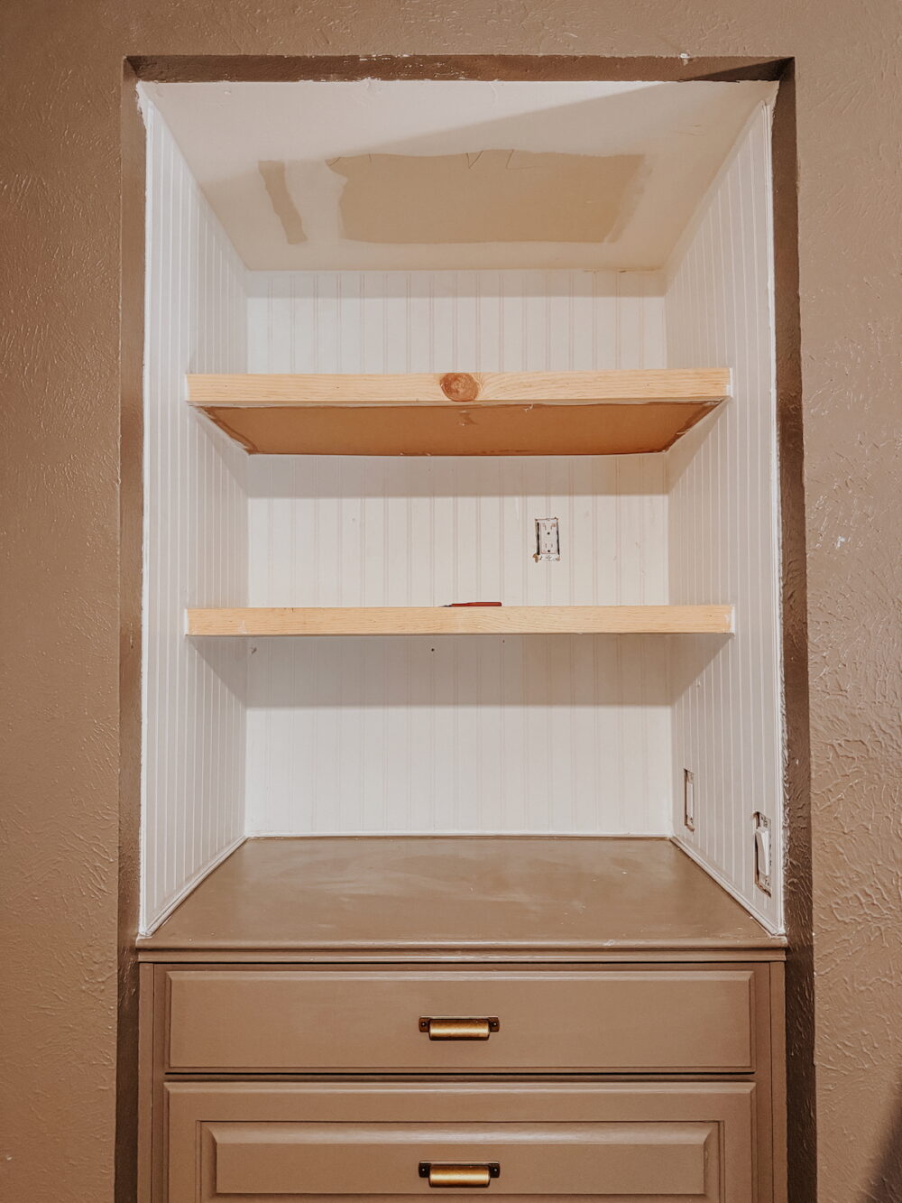 DIY wood floating shelves in a 3-sided nook with a built-in dresser underneath