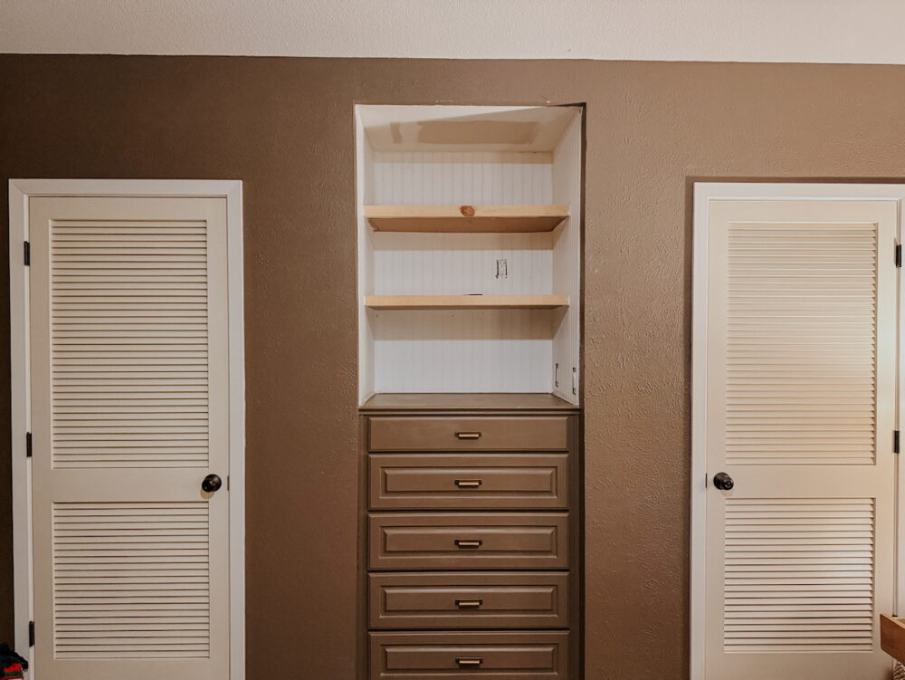 built-in nook in a room painted brown, with DIY floating shelves above a built-in dresser
