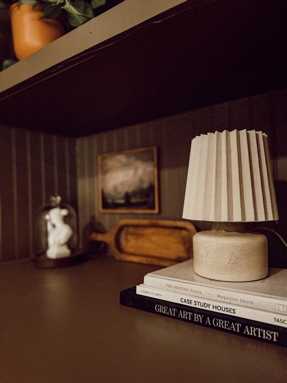 close up of lamp and styling on built in shelves