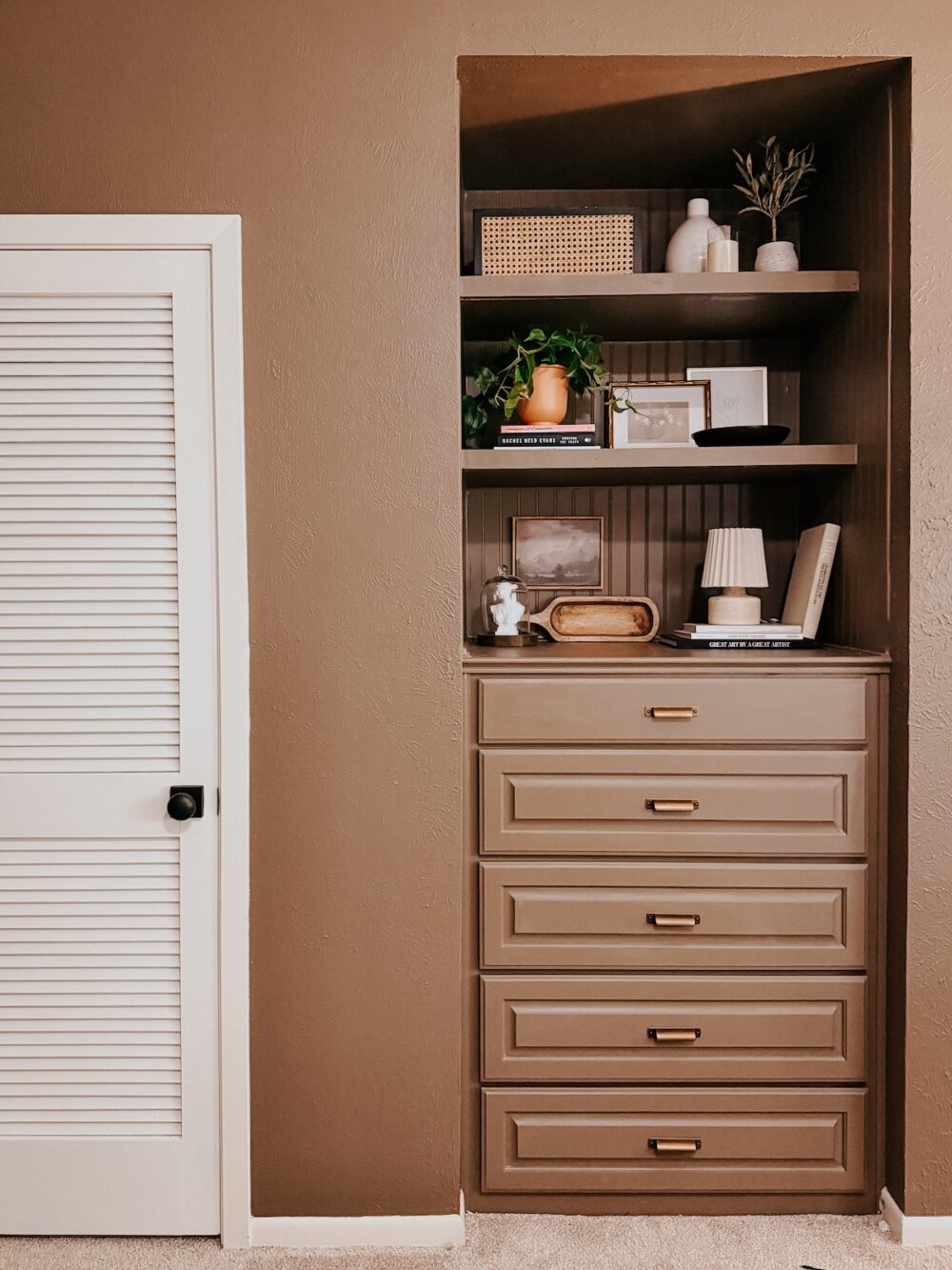 built in shelves in a bedroom styled with simple styling