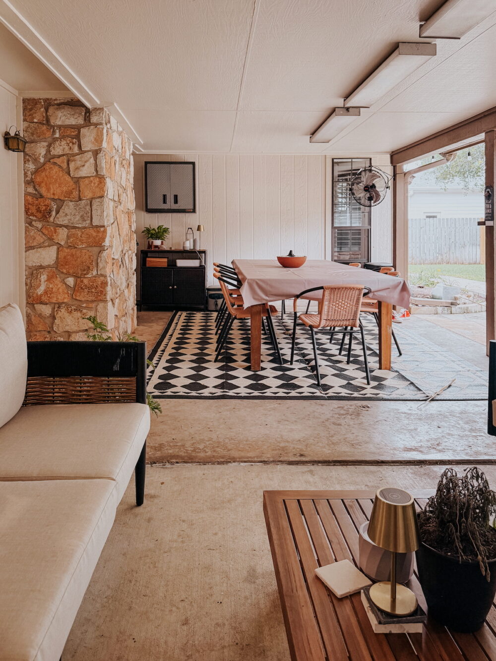 large back patio with dining table and diamond rug