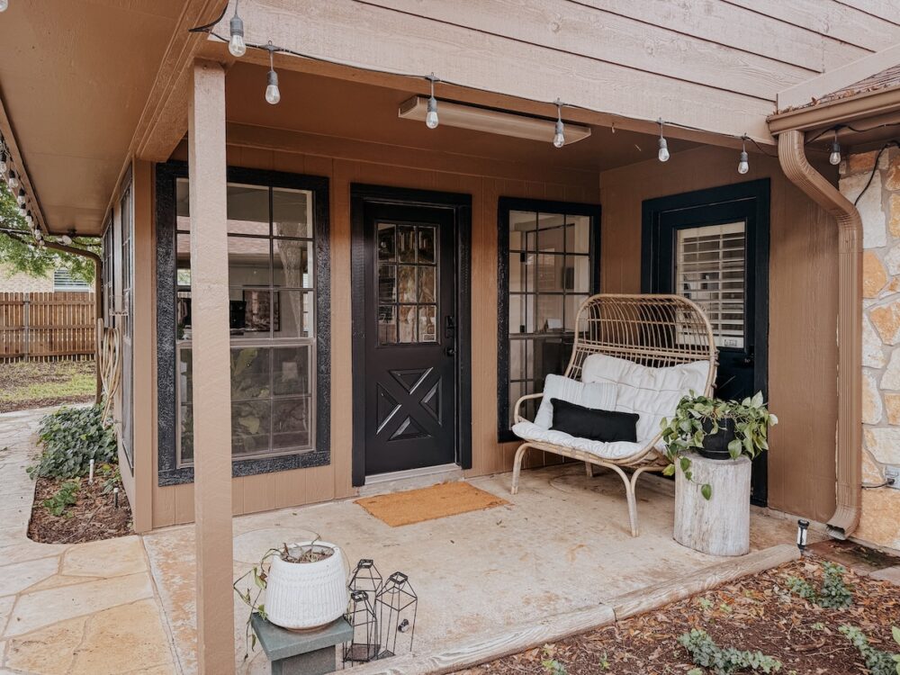 a small patio with brown siding and black trim