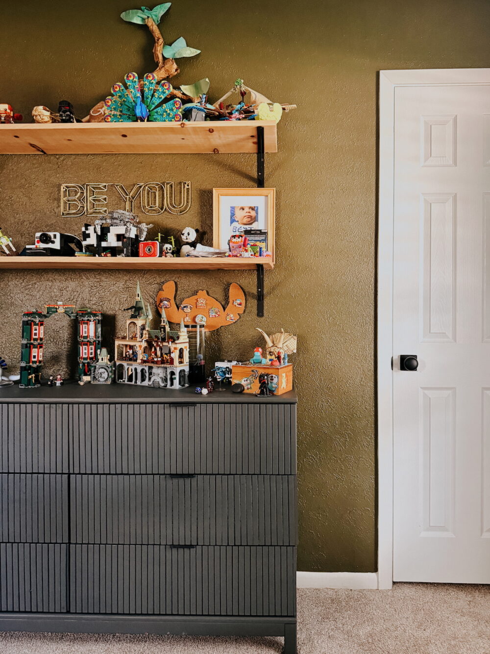 dark green bedroom with a dark gray dresser
