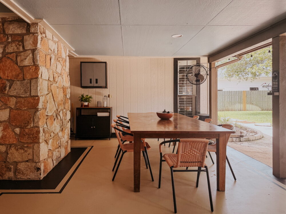large outdoor patio with a covering and a painted concrete floor
